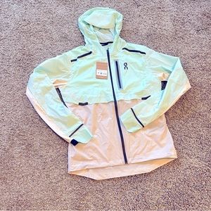 On Running Men Medium weather jacket color is creek and pearl brand new with tag